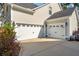 Spacious three car garage showcasing multiple doors and a well-maintained driveway at 1543 Gemstone Dr, Mount Pleasant, SC 29464