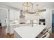 A well-appointed kitchen featuring a large island, white cabinets, and stainless steel appliances at 1543 Gemstone Dr, Mount Pleasant, SC 29464