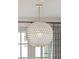 Close-up of a stunning light fixture that adds elegance and character to this stylish dining space at 1543 Gemstone Dr, Mount Pleasant, SC 29464