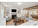 Comfortable living room with exposed beams, fireplace, TV, and neutral tones providing a cozy and welcoming space at 1543 Gemstone Dr, Mount Pleasant, SC 29464