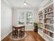 Cozy office features hardwood floors, bright windows, and custom shelving filled with books at 1543 Gemstone Dr, Mount Pleasant, SC 29464