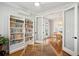 Office with glass table, ceiling fan, custom book shelves, and view into the dining room at 1543 Gemstone Dr, Mount Pleasant, SC 29464
