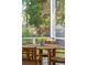 Screened porch with a round table and chairs with views of the backyard and landscaping at 1543 Gemstone Dr, Mount Pleasant, SC 29464