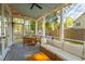 Inviting screened porch featuring ample seating, wood table, string lights, and views of the yard at 1543 Gemstone Dr, Mount Pleasant, SC 29464