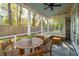 Cozy screened-in porch with a ceiling fan, sectional seating, and view to the fenced in back yard at 1543 Gemstone Dr, Mount Pleasant, SC 29464