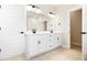 Spacious bathroom with double sinks, white cabinets, modern fixtures, and a large mirror at 1577 Periwinkle Dr, Mount Pleasant, SC 29466