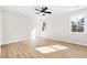 A bright bedroom with natural light, wood flooring, white walls, and a ceiling fan at 1577 Periwinkle Dr, Mount Pleasant, SC 29466