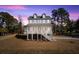 Charming two-story home with landscaped yard and classic coastal architecture at twilight at 1577 Periwinkle Dr, Mount Pleasant, SC 29466