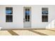 Classic front door with sidelight windows, set between two large picture windows at 1577 Periwinkle Dr, Mount Pleasant, SC 29466