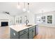 Bright, open kitchen featuring a large island with a sink, modern lighting, and hardwood floors at 1577 Periwinkle Dr, Mount Pleasant, SC 29466