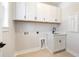 Well-organized laundry room with white cabinets, sink, and ample storage, making chores more convenient at 1577 Periwinkle Dr, Mount Pleasant, SC 29466