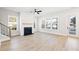 Bright living room with a fireplace, ample natural light from multiple windows, and hardwood flooring at 1577 Periwinkle Dr, Mount Pleasant, SC 29466