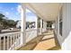 Expansive porch with white pillars and railing provides ample space for outdoor seating at 1577 Periwinkle Dr, Mount Pleasant, SC 29466