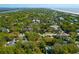 Expansive aerial view of the property with beach access and other homes, surrounded by lush greenery and a river at 17 24Th Ave, Isle of Palms, SC 29451