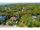 Aerial view capturing a coastal community with homes surrounded by lush trees and the ocean in the distance at 17 24Th Ave, Isle of Palms, SC 29451