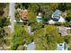 Aerial view of a home with a swimming pool surrounded by lush greenery and trees at 17 24Th Ave, Isle of Palms, SC 29451
