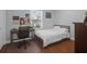 Simple bedroom setup featuring a bed, desk, chair and view of outside greenery at 17 24Th Ave, Isle of Palms, SC 29451