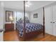 Bright bedroom featuring a four poster bed, hardwood floors, and natural light from a window at 17 24Th Ave, Isle of Palms, SC 29451