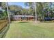 A charming brick home has a well-kept lawn and a relaxing front porch, ideal for enjoying the outdoors at 17 24Th Ave, Isle of Palms, SC 29451