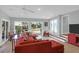 Spacious living room with tile flooring, white walls, and access to outdoor space at 17 24Th Ave, Isle of Palms, SC 29451