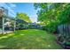 Spacious backyard with a well-manicured lawn, mature trees, and a classic wooden fence creating a private outdoor space at 1722 S Nicole Pl, Charleston, SC 29414