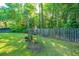 Expansive backyard showcasing a verdant lawn, wooden fence, and mature trees, perfect for outdoor enjoyment and privacy at 1722 S Nicole Pl, Charleston, SC 29414