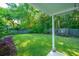 Well-maintained backyard with green lawn, wood fence, flower bed and mature trees providing a serene outdoor space at 1722 S Nicole Pl, Charleston, SC 29414