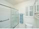 Well-lit bathroom features a shower with glass door and built in shelving on side wall at 1722 S Nicole Pl, Charleston, SC 29414