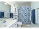 Bathroom with large vanity, toilet, and shower with blue floral curtain at 1722 S Nicole Pl, Charleston, SC 29414