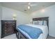 Comfortable bedroom features a ceiling fan, large bed, and dresser with dark furniture at 1722 S Nicole Pl, Charleston, SC 29414