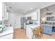 Open kitchen with stainless appliances, white cabinets, and adjacent dining and living areas at 1722 S Nicole Pl, Charleston, SC 29414
