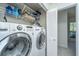 Laundry room with washer, dryer, wire shelving, and an ironing board at 1722 S Nicole Pl, Charleston, SC 29414