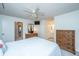 Bright main bedroom features a ceiling fan and access to the en suite bathroom and closet at 1722 S Nicole Pl, Charleston, SC 29414