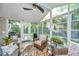 Relaxing sunroom with a ceiling fan, seating, string lights, and outdoor access at 1722 S Nicole Pl, Charleston, SC 29414