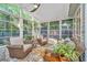 Bright sunroom with a ceiling fan, wicker seating, and a view of the backyard at 1722 S Nicole Pl, Charleston, SC 29414