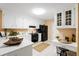 Bright kitchen with white cabinets, black appliances, counter seating, and ample counter space at 192 Bamert St, Summerville, SC 29483
