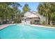Beautiful in-ground swimming pool, screened in porch, and lush landscaping in backyard at 192 Bamert St, Summerville, SC 29483