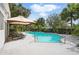 Inviting backyard with a private pool, lounge chairs, a sunshade, and lush landscaping at 192 Bamert St, Summerville, SC 29483