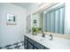 Well-lit bathroom featuring a stylish vanity, checkerboard floor, and modern decor at 2013 Grey Marsh Rd, Mount Pleasant, SC 29466
