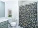 This bathroom features a floral shower curtain, updated faucet, and framed artwork above the toilet at 2013 Grey Marsh Rd, Mount Pleasant, SC 29466