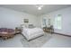 This bedroom is staged with a reading chair, desk, and light neutral tones at 2013 Grey Marsh Rd, Mount Pleasant, SC 29466