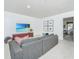 Modern living room with sectional sofa, TV, and view of outdoor space at 2013 Grey Marsh Rd, Mount Pleasant, SC 29466