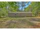 This brick home's serene backyard has mature trees shading the lawn and ample space at 202 Oak Cir, Walterboro, SC 29488
