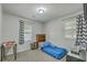 Well-lit bedroom with carpet, two windows with patterned curtains, and basic furniture at 202 Oak Cir, Walterboro, SC 29488