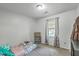 Bright bedroom features a window, carpeted floor, and is simply furnished with a twin bed at 202 Oak Cir, Walterboro, SC 29488