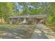 Classic brick home showcasing an attached carport and well-kept yard with blooming shrubs at 202 Oak Cir, Walterboro, SC 29488