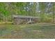 Charming single-story brick home featuring a covered porch and lush, mature landscaping at 202 Oak Cir, Walterboro, SC 29488