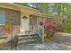 Inviting front entrance with a decorative door, concrete steps, and vibrant azalea bush at 202 Oak Cir, Walterboro, SC 29488