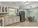 The kitchen features white cabinets and modern appliances, complemented by an adjacent dining area at 202 Oak Cir, Walterboro, SC 29488