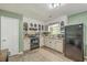 Classic kitchen with white cabinetry, modern appliances, and a view to the dining area at 202 Oak Cir, Walterboro, SC 29488